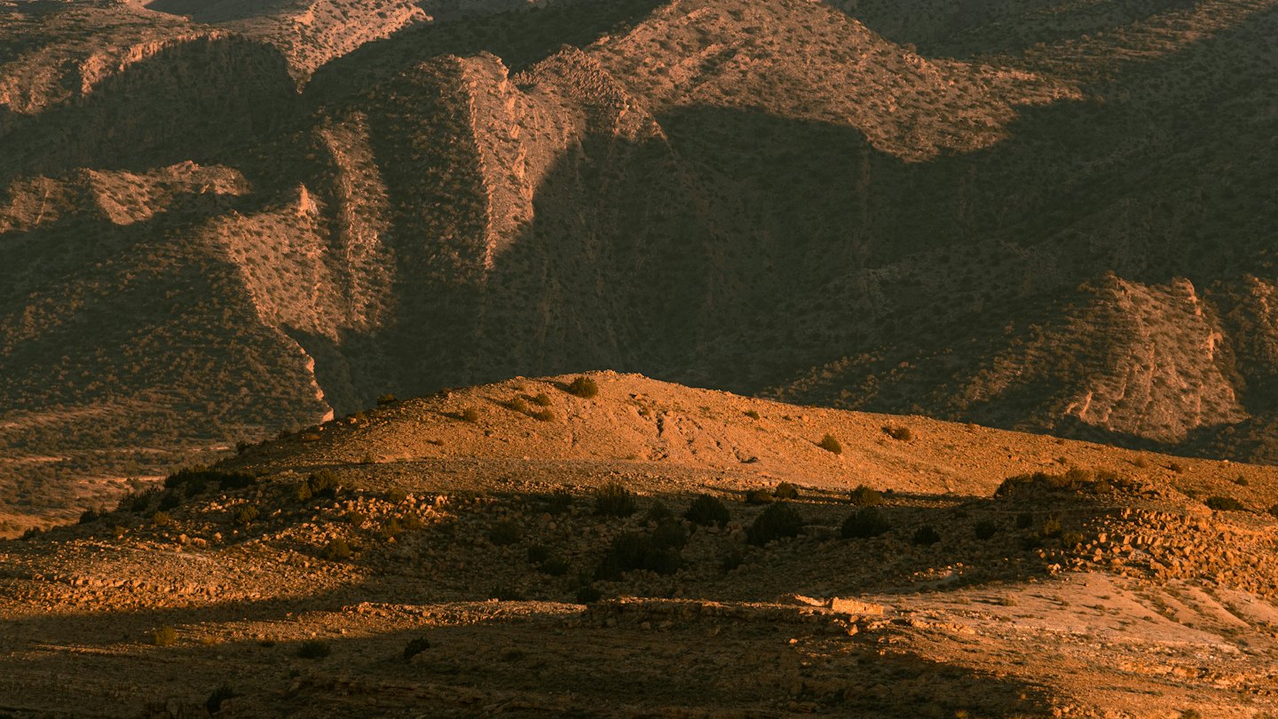 Rugged mountains rise above the arid desert landscape.
